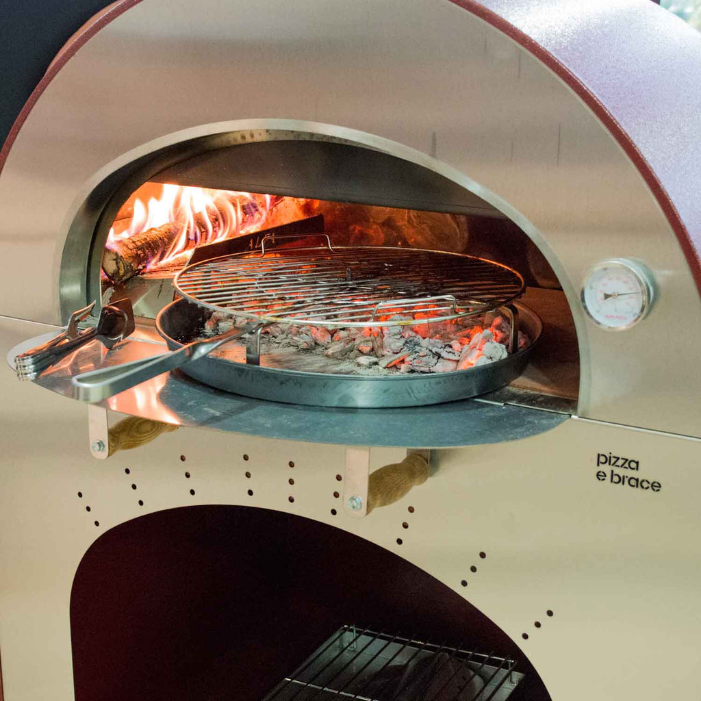 Round wire grilling grate inside grill oven with open flame