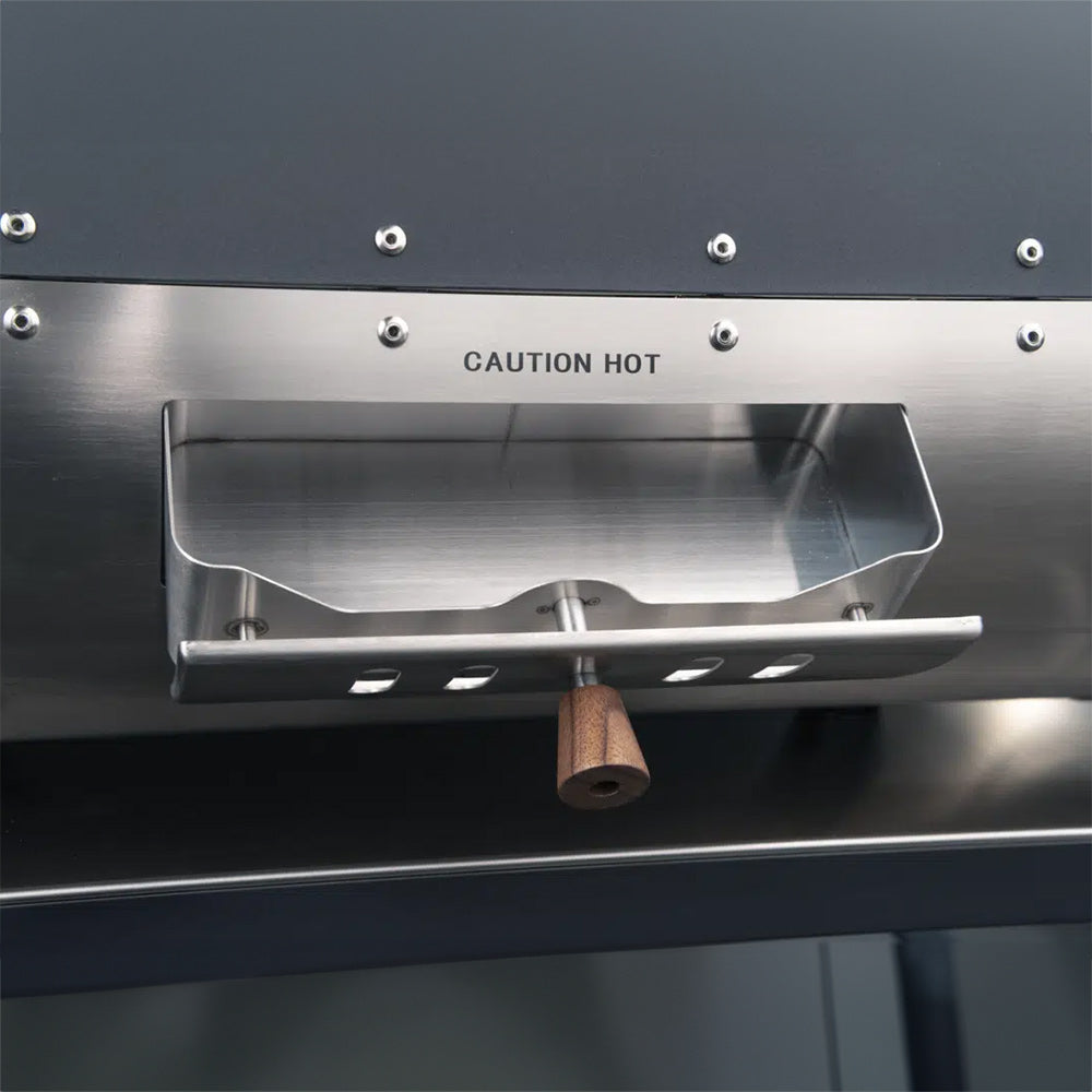 Pizza oven drip tray with “CAUTION HOT” label above vented opening