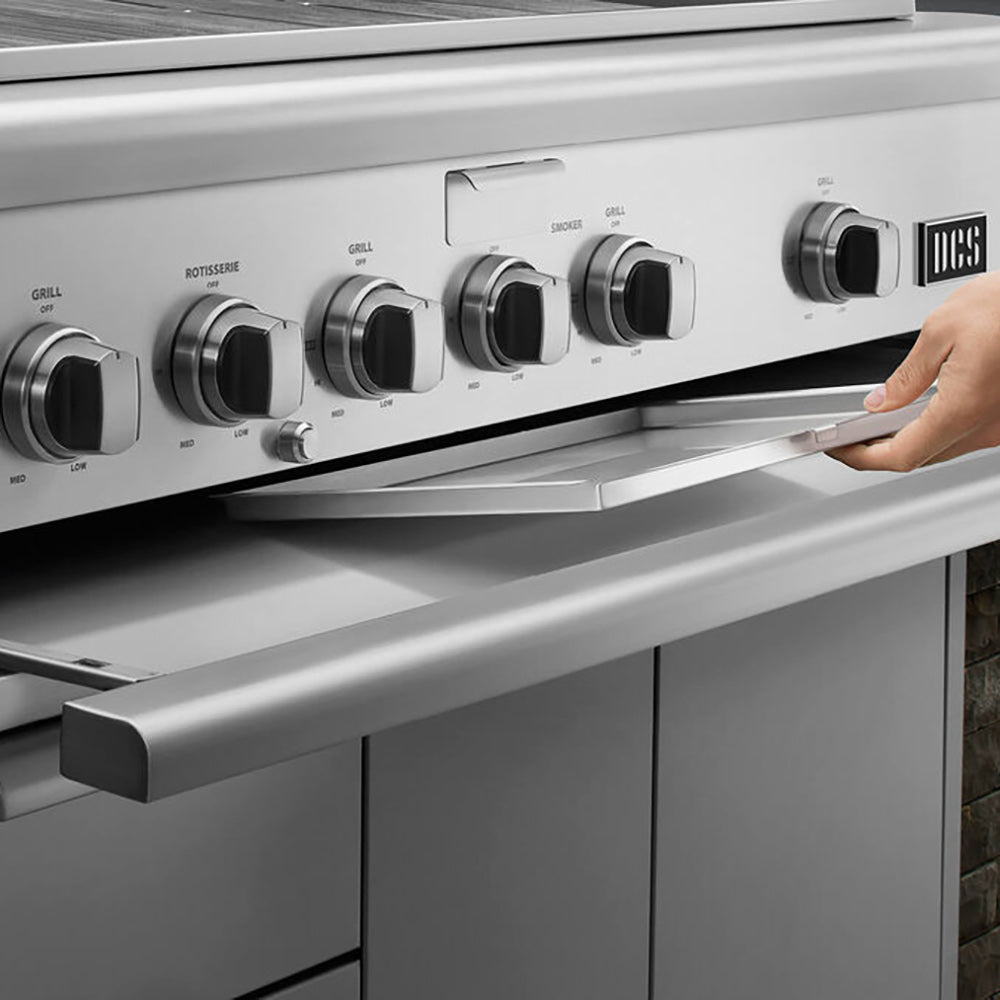 Built-in gas grill front controls with four knobs and hand adjusting a side control