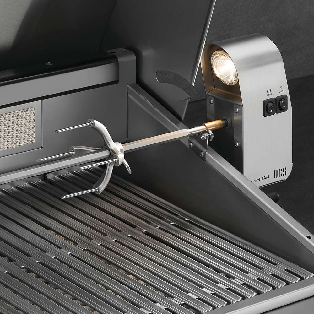 Built-in gas grill with rotisserie rod and burners exposed inside open hood