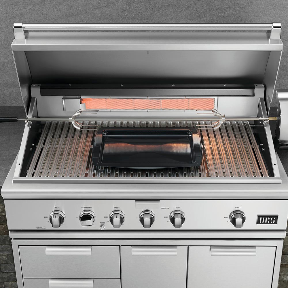 Open built-in gas grill showing cooking grates and glowing infrared burner