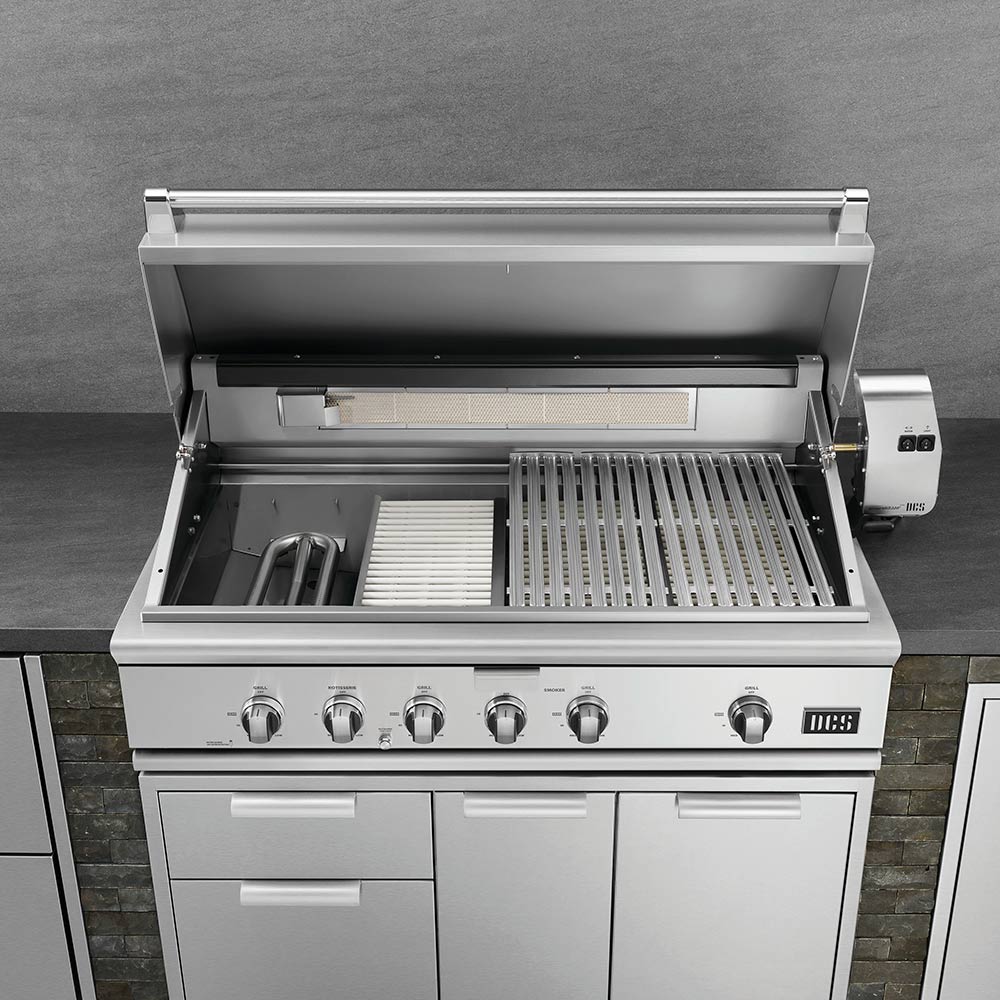 Open built-in gas grill with main and secondary cooking grates exposed