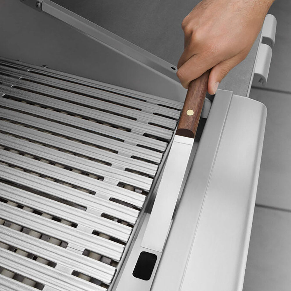 Built-in grill with removable grease tray and handle near the burner area