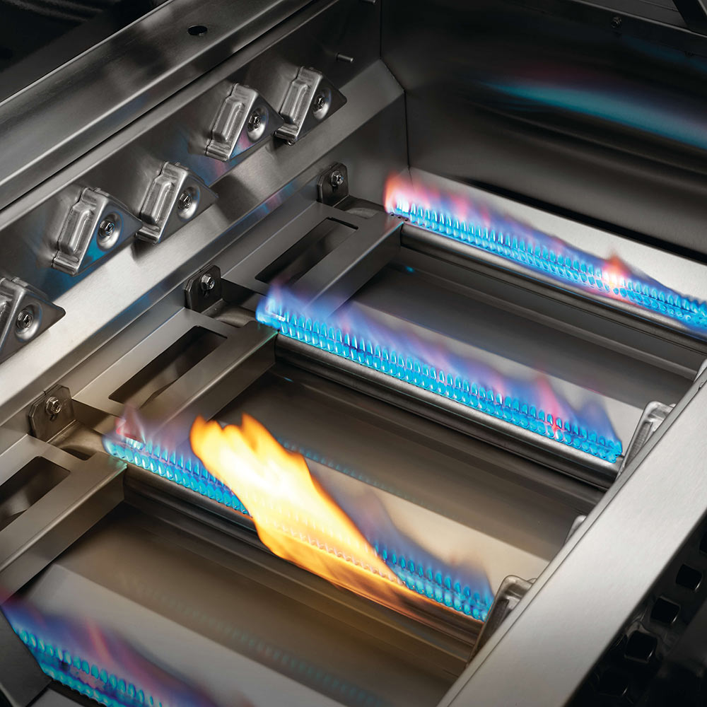 Built-in gas grill firebox with glowing blue burner flames