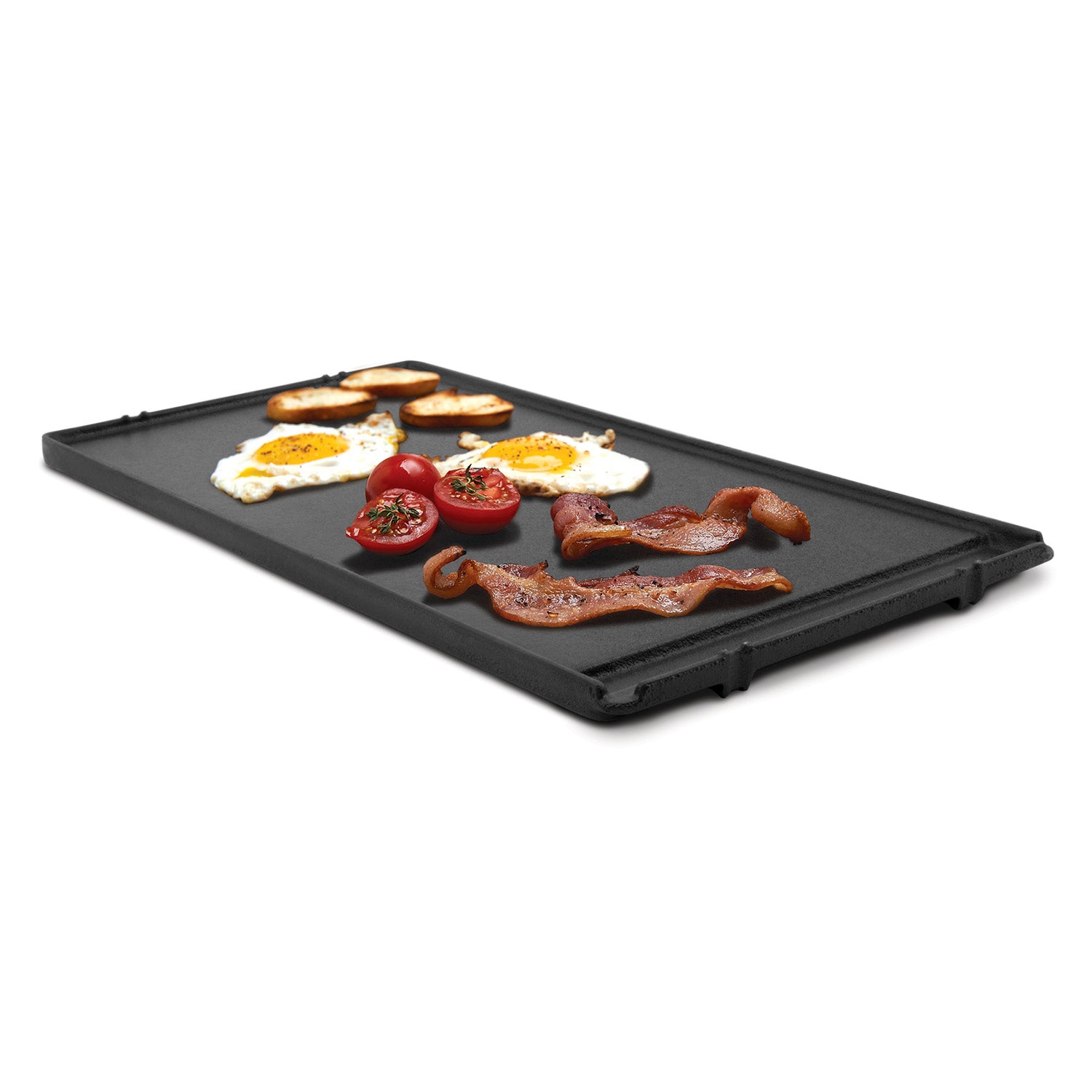 Black cast iron griddle with side handles, filled with cooked meat and vegetables