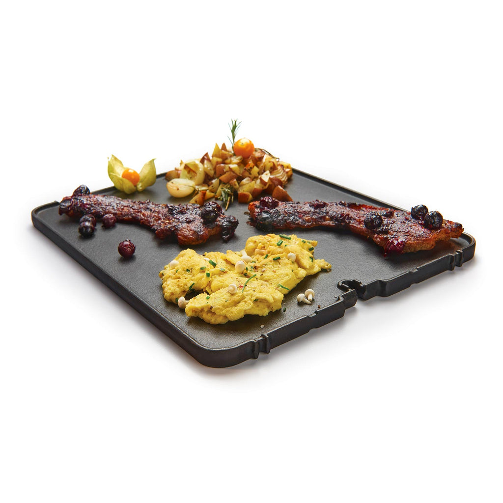 Cast iron griddle with ridged cooking surface and side handles