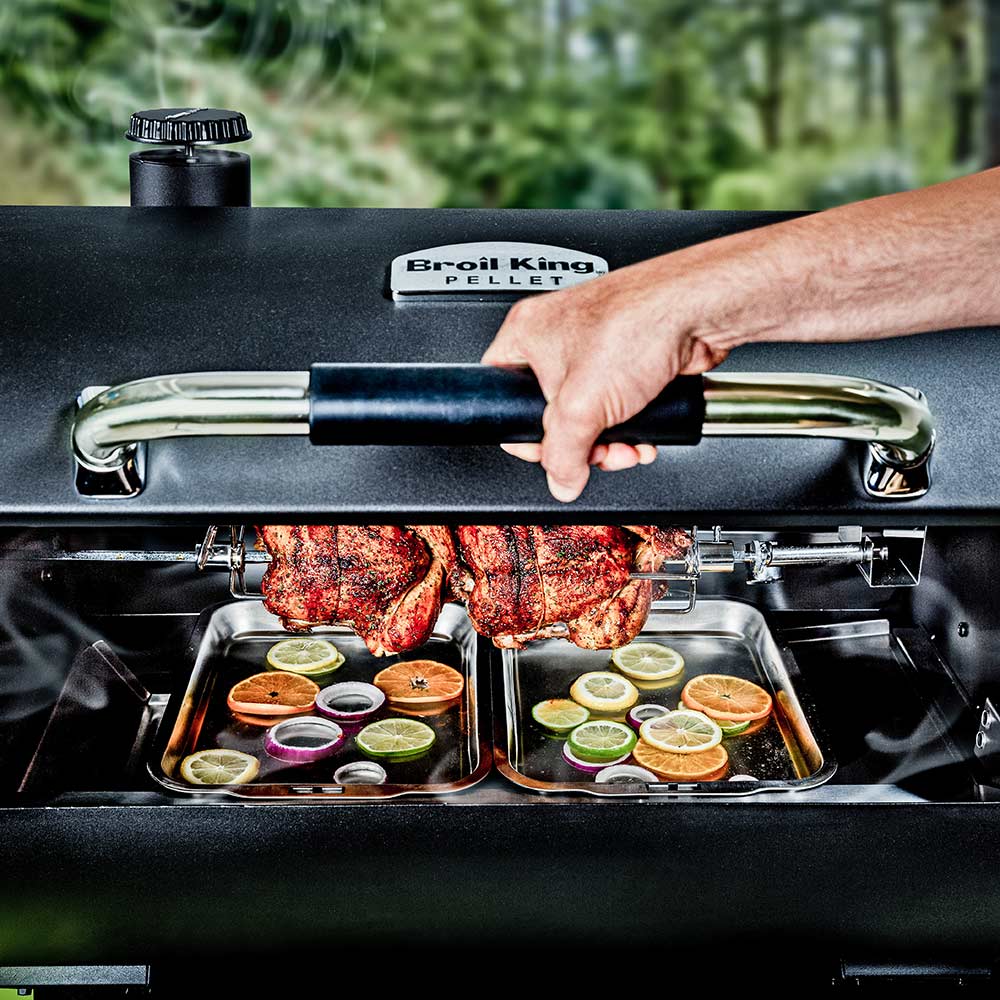 Pellet smoker grill with roasted meat on the cooking grates and smoke