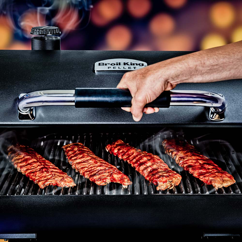 Pellet smoker grill with grilled sausages on the cooking grates