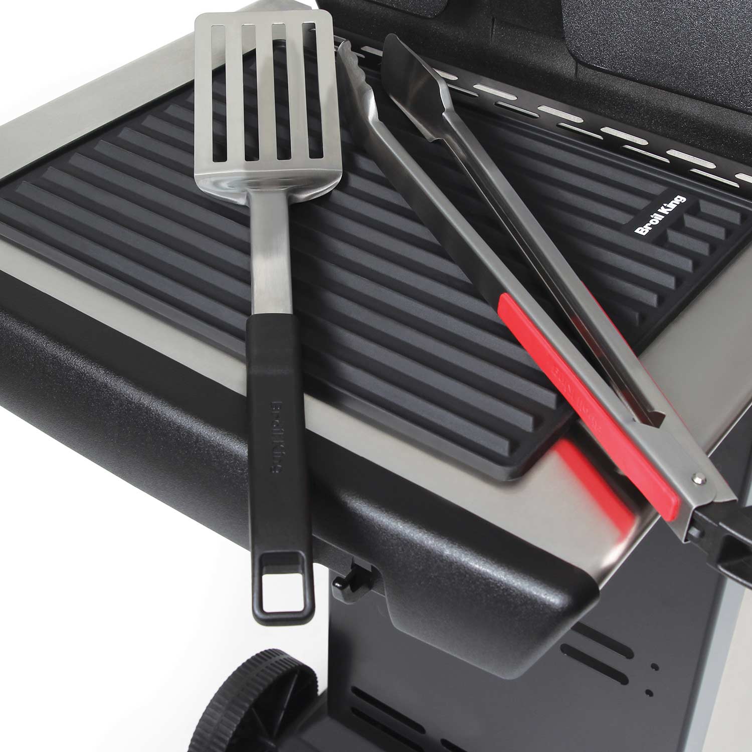 Silicone grill side shelf mat on grill side shelf with spatula and tongs