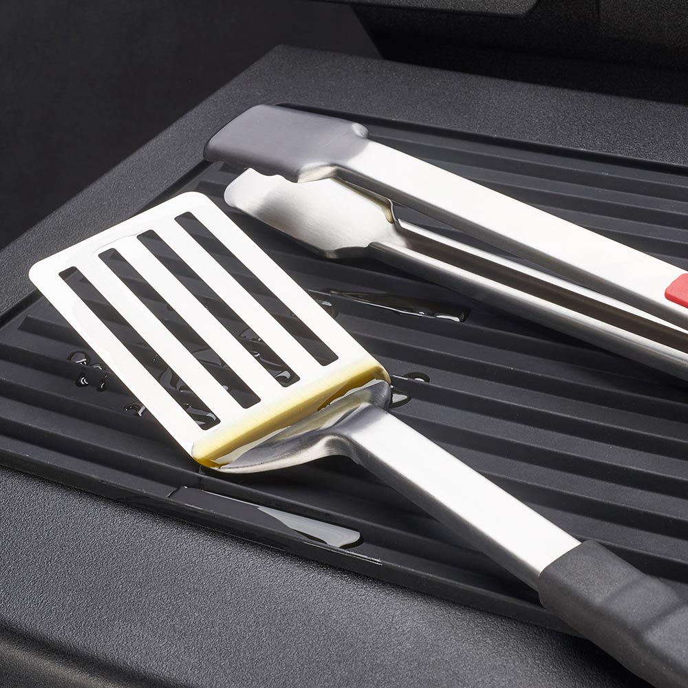 Silicone grill side shelf mat with slotted spatula and grilling tools