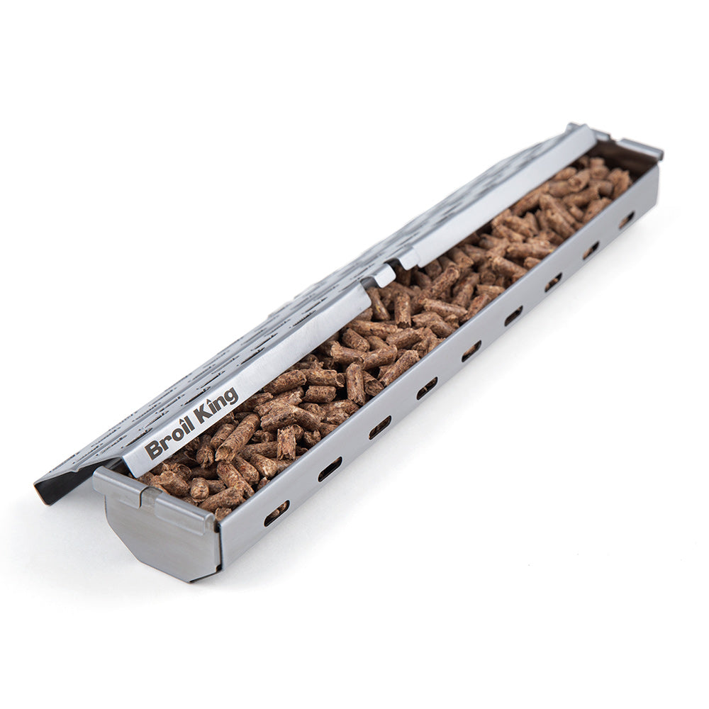 Stainless steel pellet smoker box by Broil King filled with pellets, perforated sides