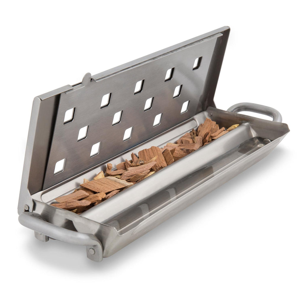 Broil King Imperial smoker box filled with wood chips behind vented front plate