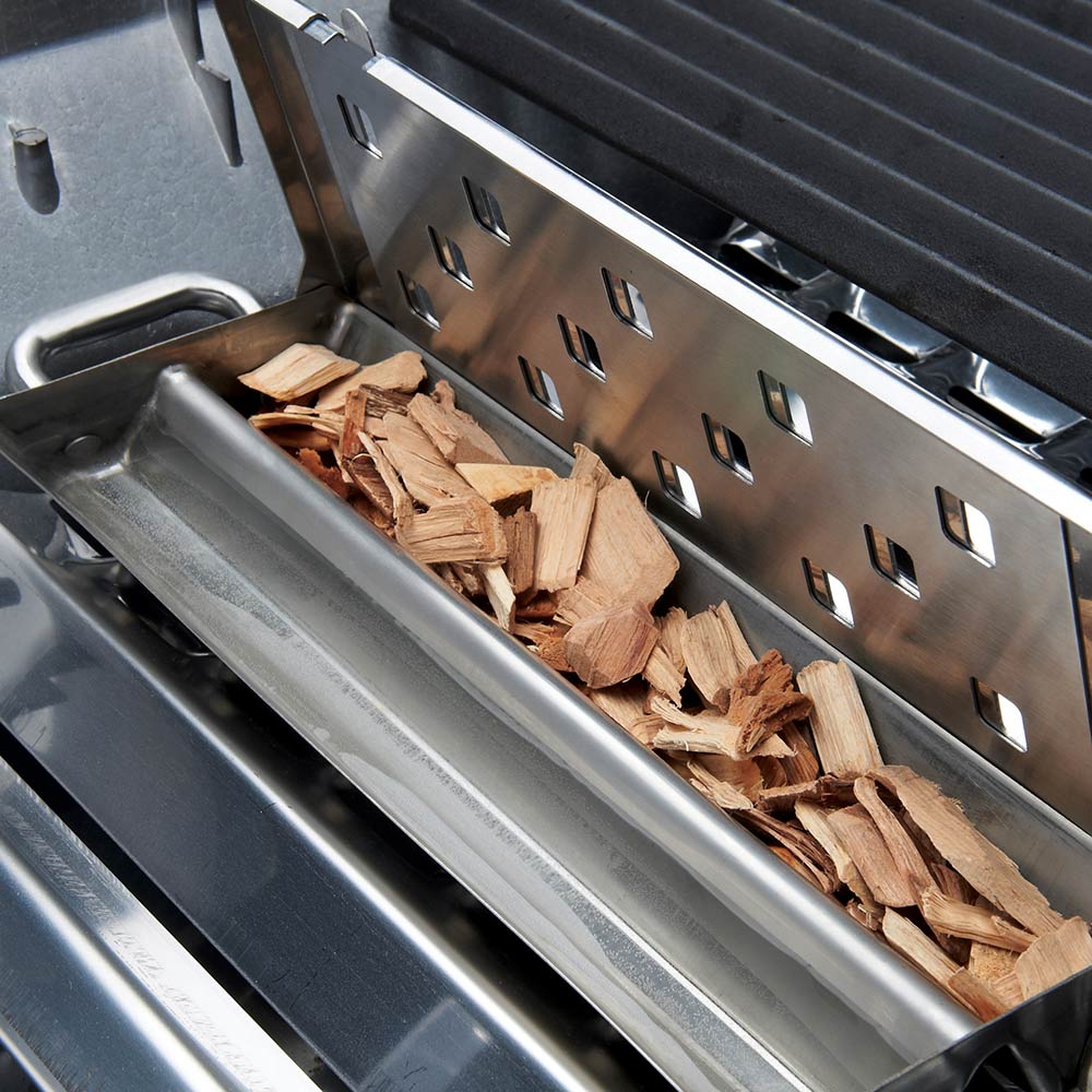 Broil King Imperial smoker box with wood chips in metal tray, vented back plate