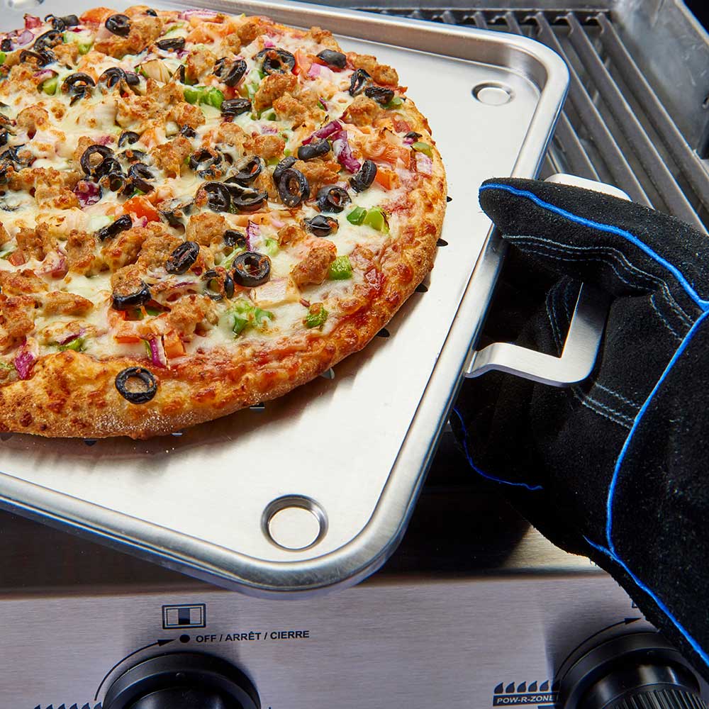 Black leather grill glove with blue trim resting on pizza tray