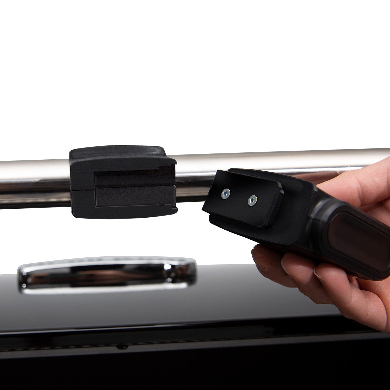 Broil King grill light being mounted on grill handle; hand holding it
