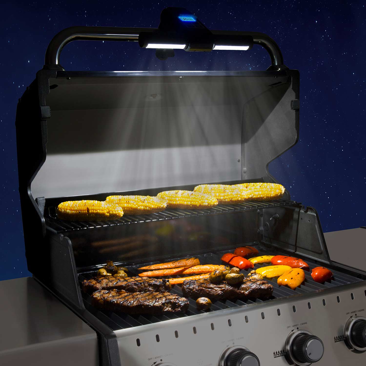Mounted Broil King grill light and timer above the grill cooking area