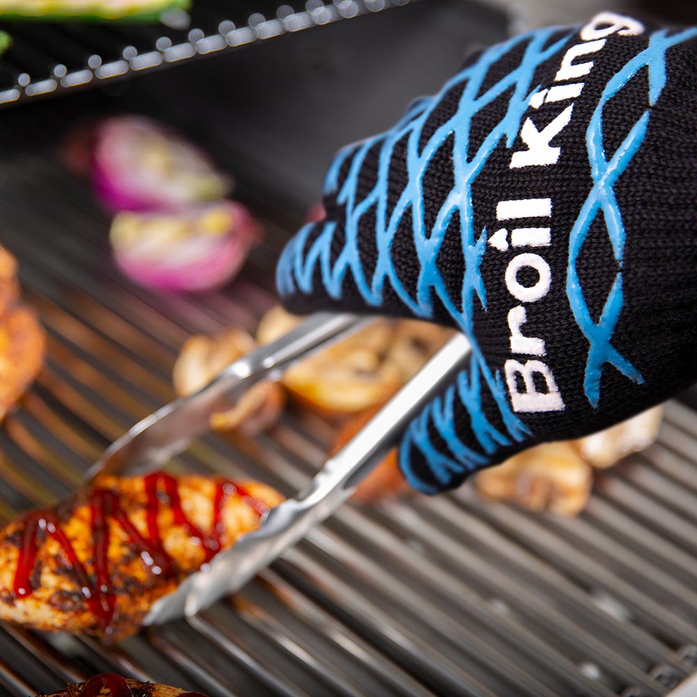 Grilling mitt sleeve, black with blue X-pattern, holding metal tongs