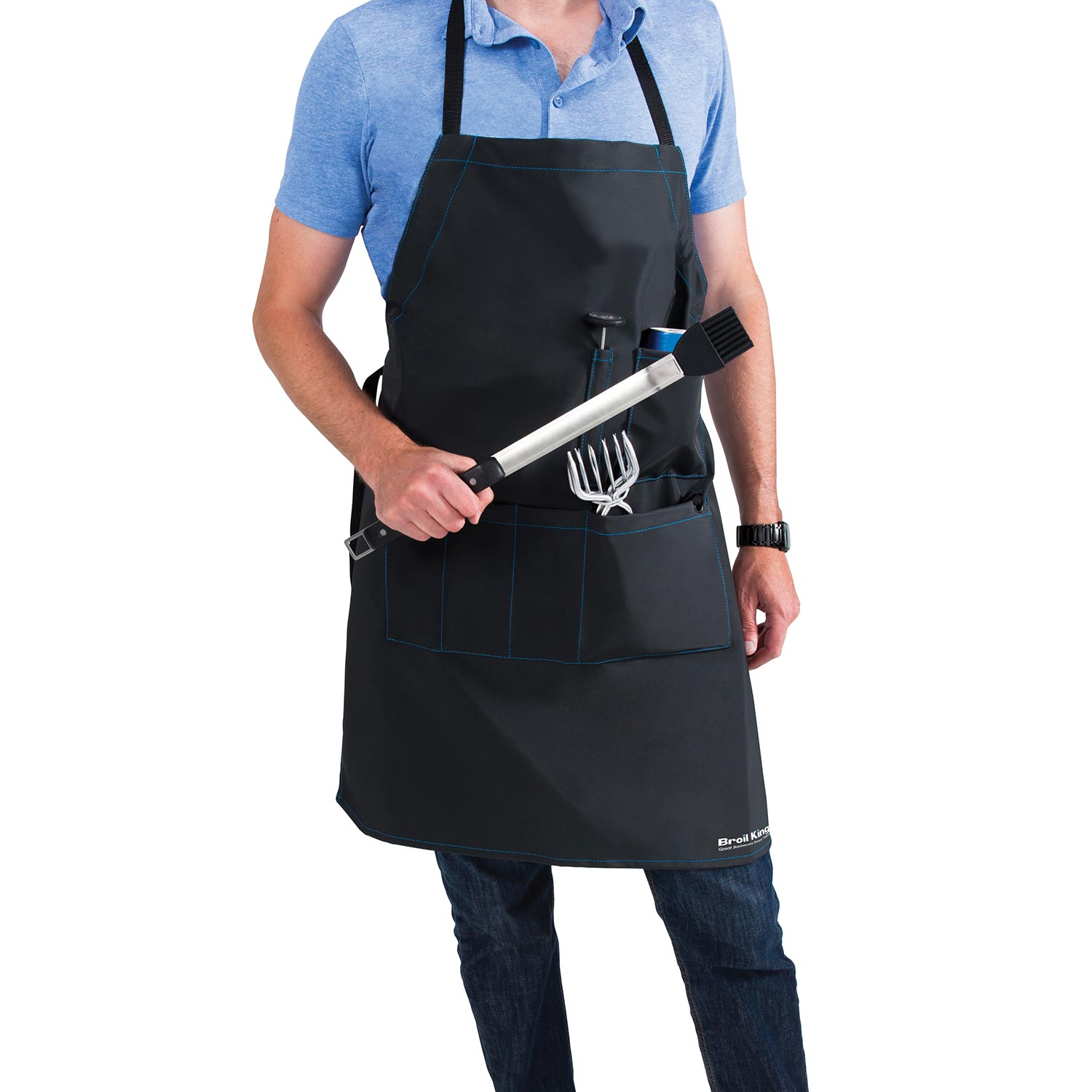 Black grilling apron worn by a person holding a metal grilling tool