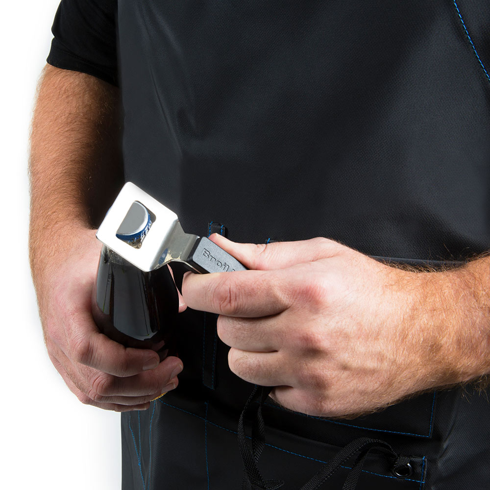 Black grilling apron buckle and strap being fastened by a hand