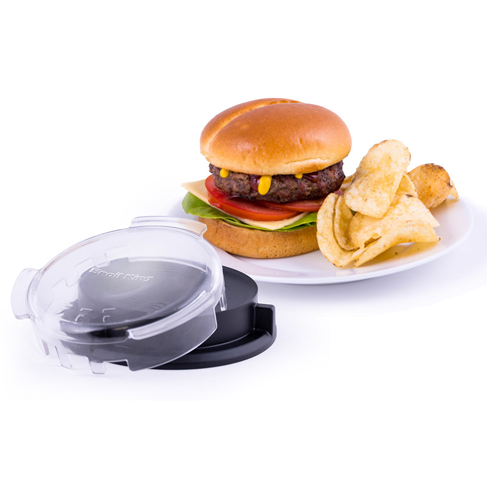 Burger press with clear lid and black base next to burger and fries