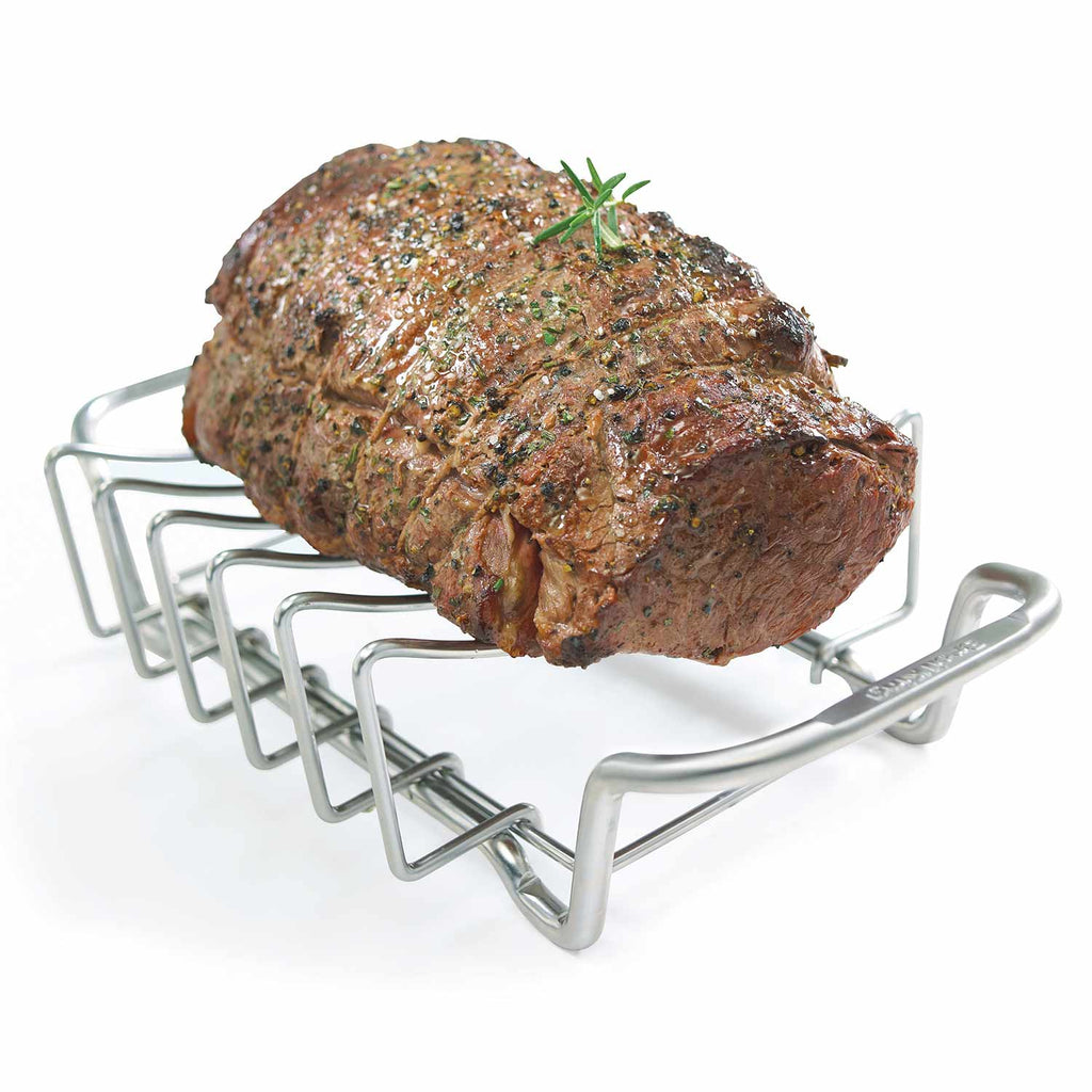 Stainless rib and roast rack holding a seasoned roast with herb sprigs