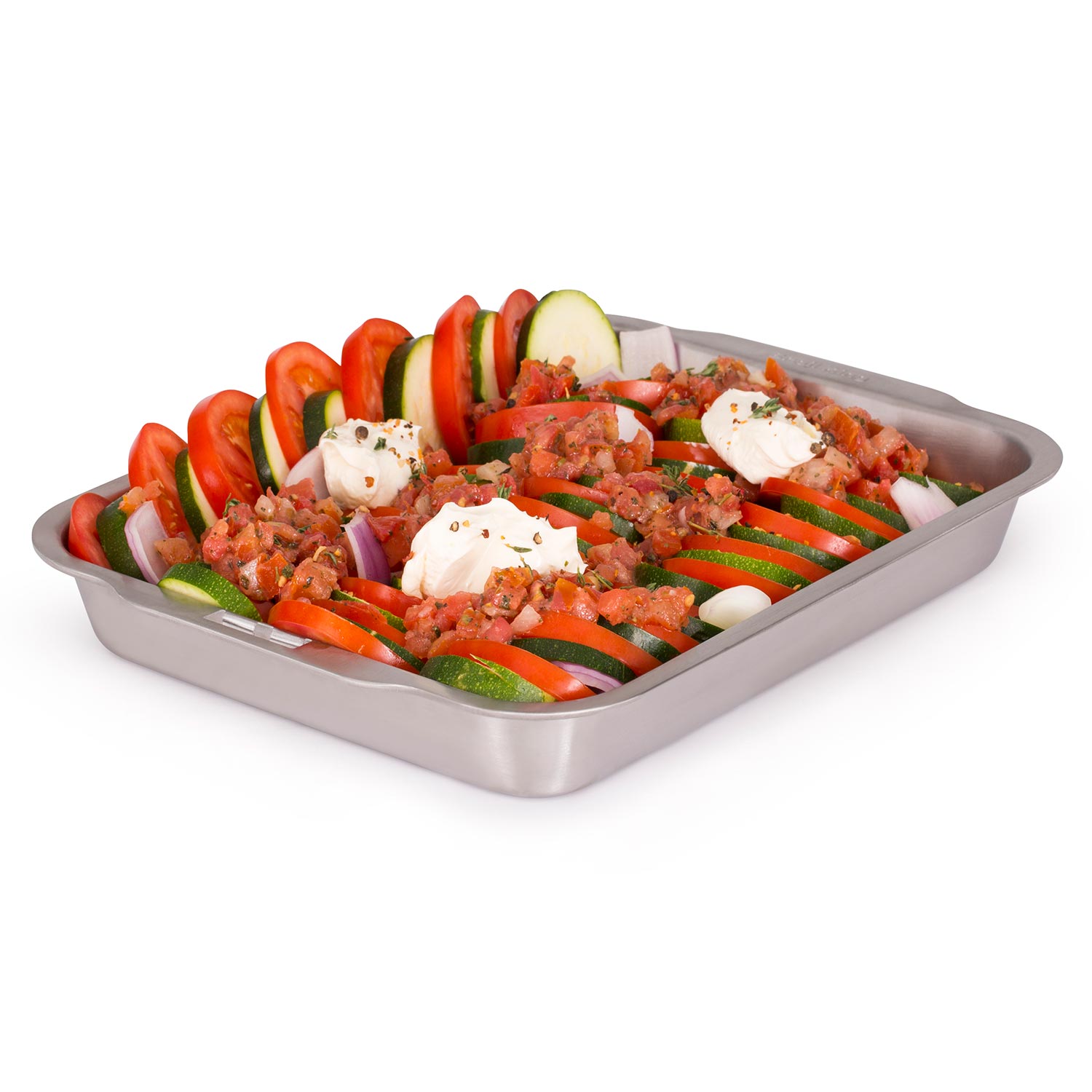 Stainless steel roasting and drip pan filled with sliced vegetables and herbs