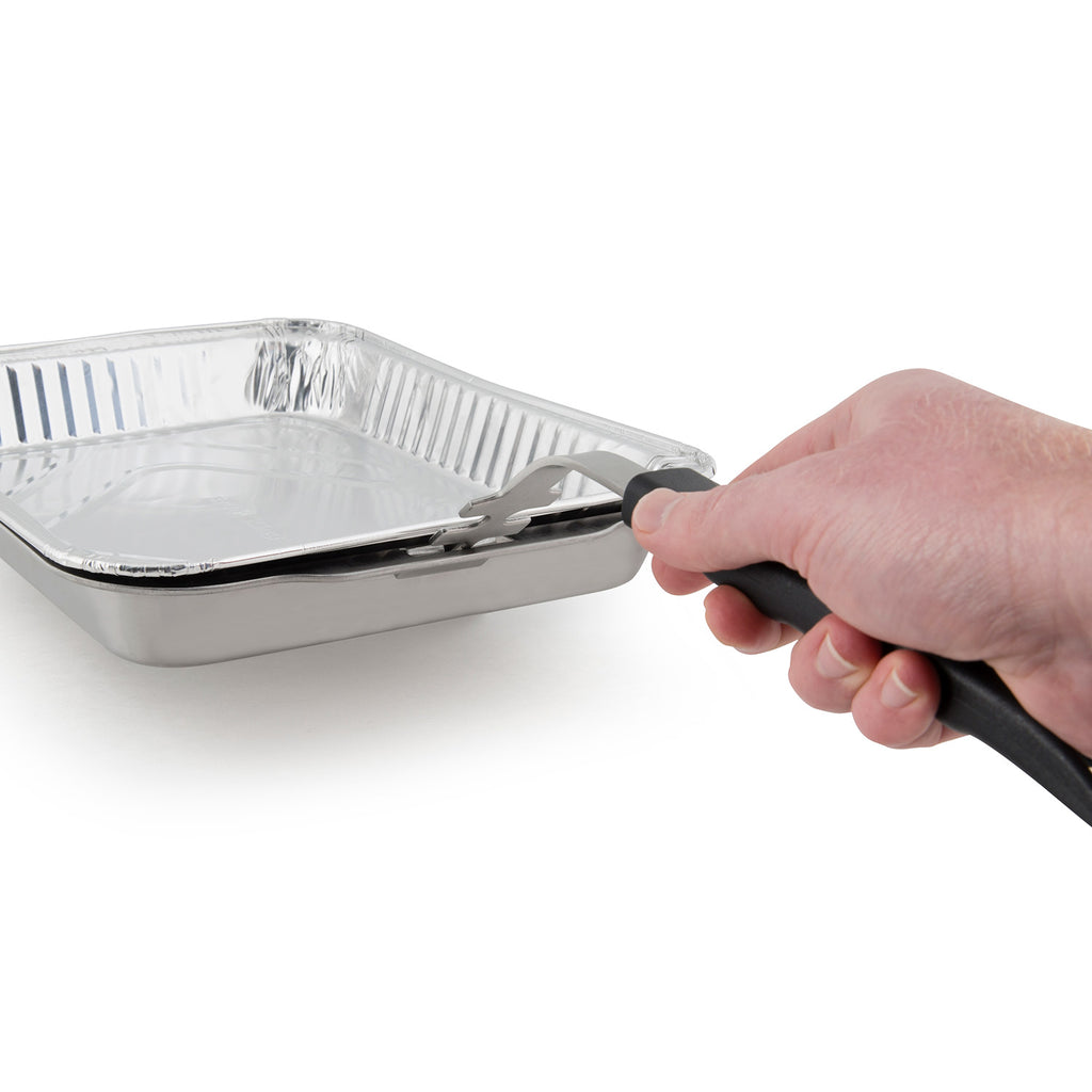 Stainless steel roasting and drip pan held with black handle tool