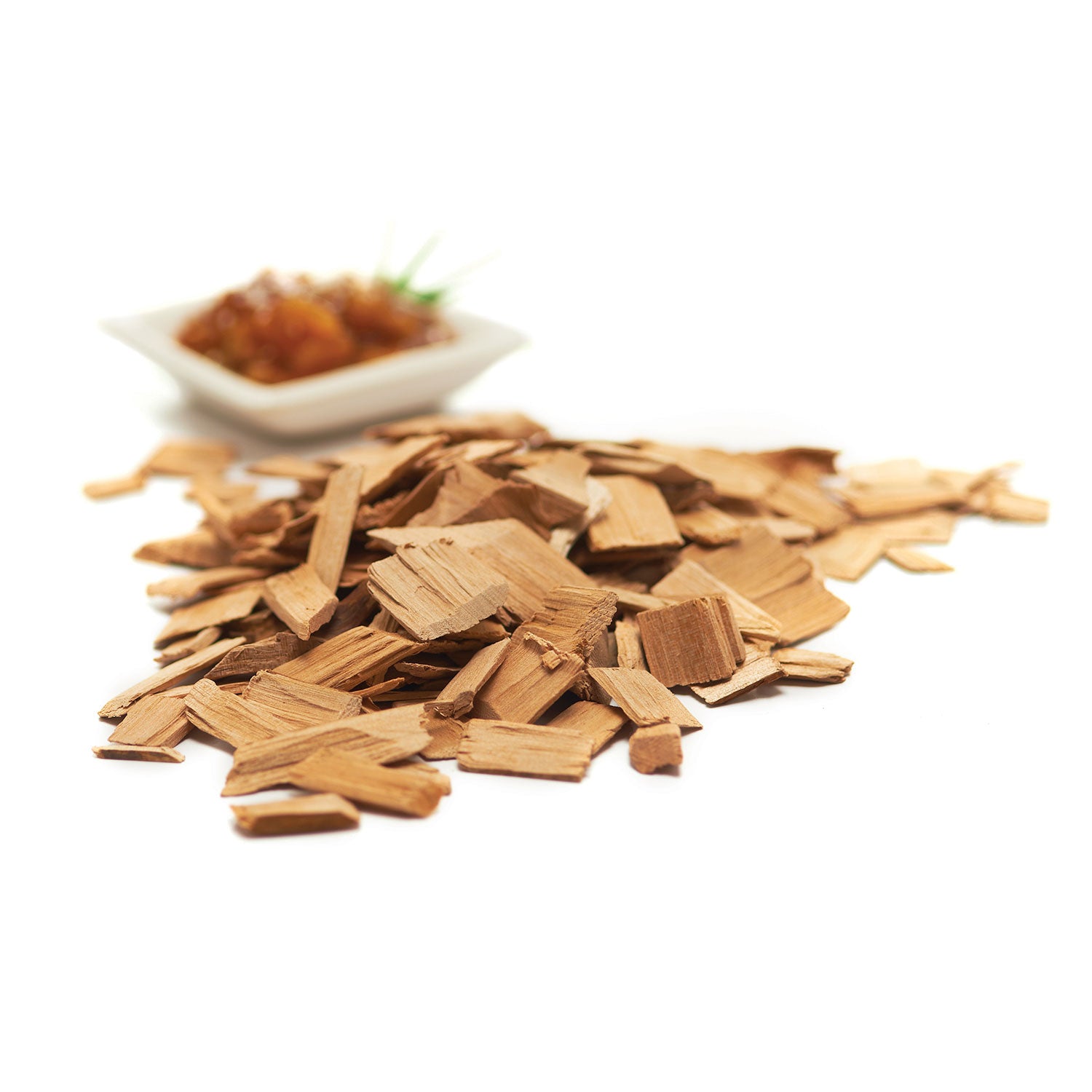 Hickory wood chips pile with small bowl of chips in background