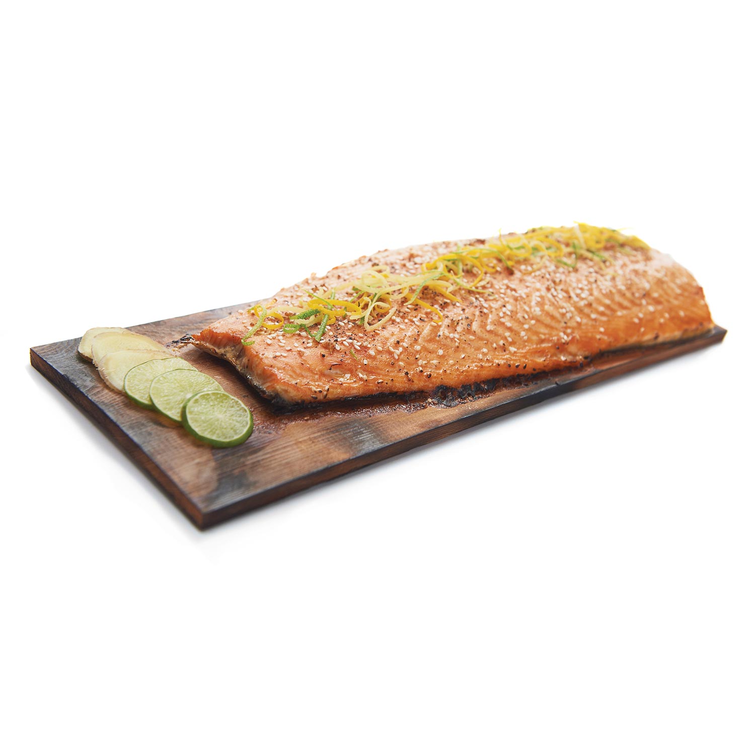 Cedar grilling plank with salmon and sliced lime on a dark wooden board