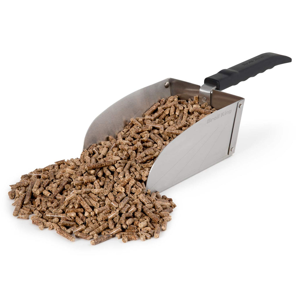 Metal scoop filled with dark pellets or charcoal; black handle attached