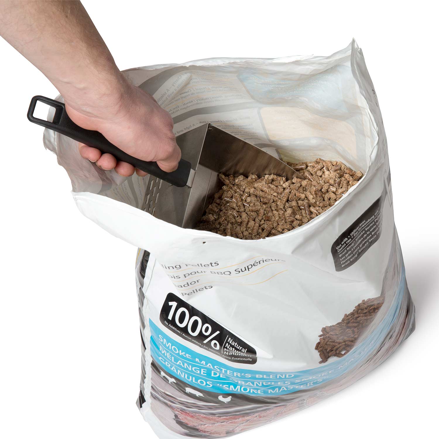 Hand uses metal scoop with black handle to scoop dark pellets from a bag