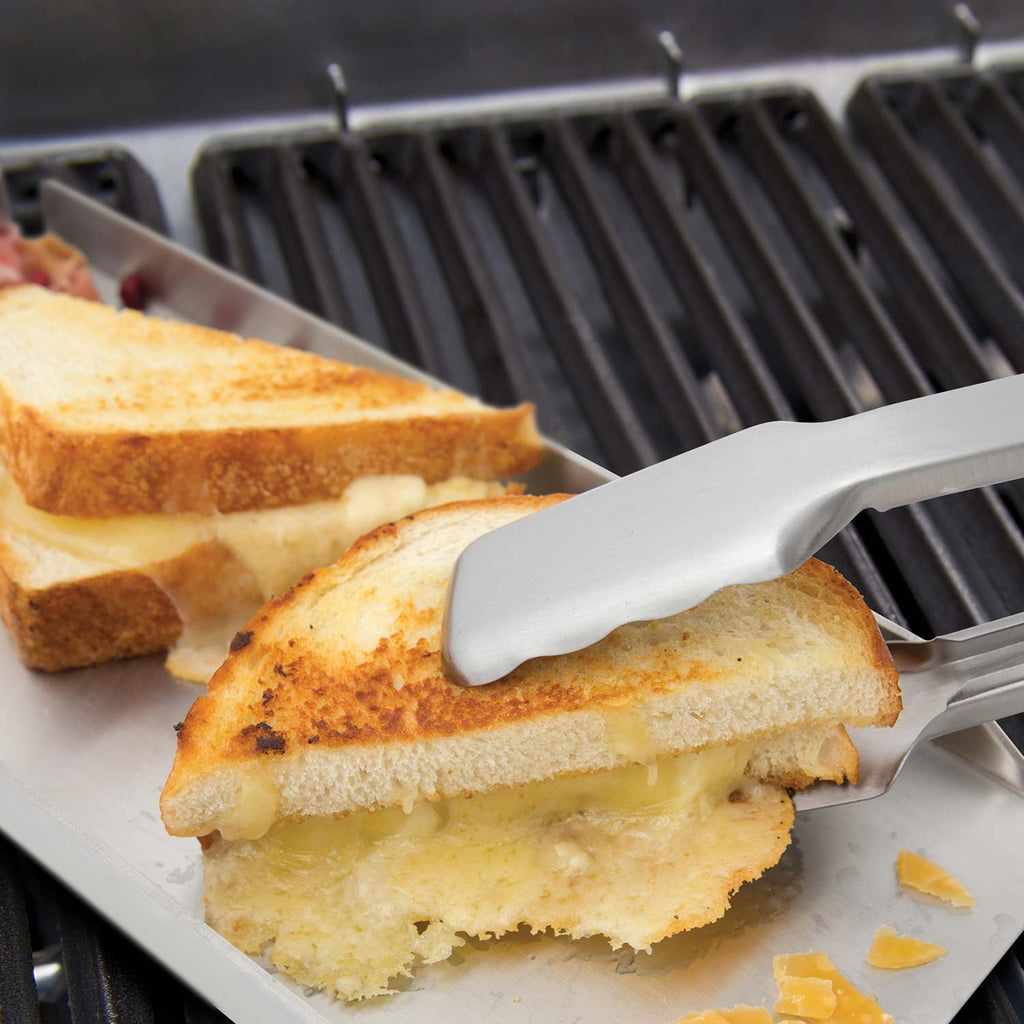 Broil King grill tool set spatula with toasted sandwiches on barbecue grill grates