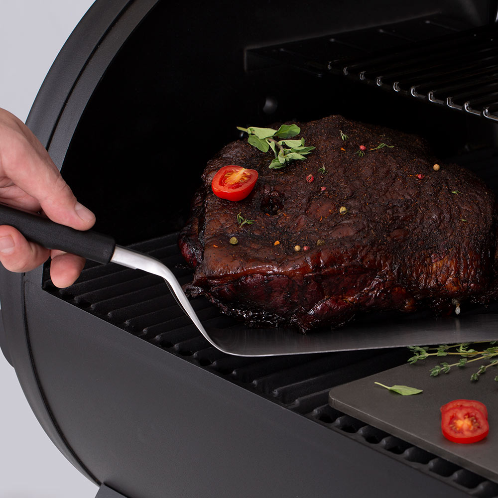 Baron Super Flipper stainless-steel spatula blade with black grip during grilling