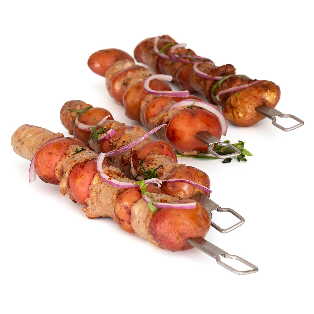 Stainless steel dual-prong skewers holding sausage and peppers, set of four