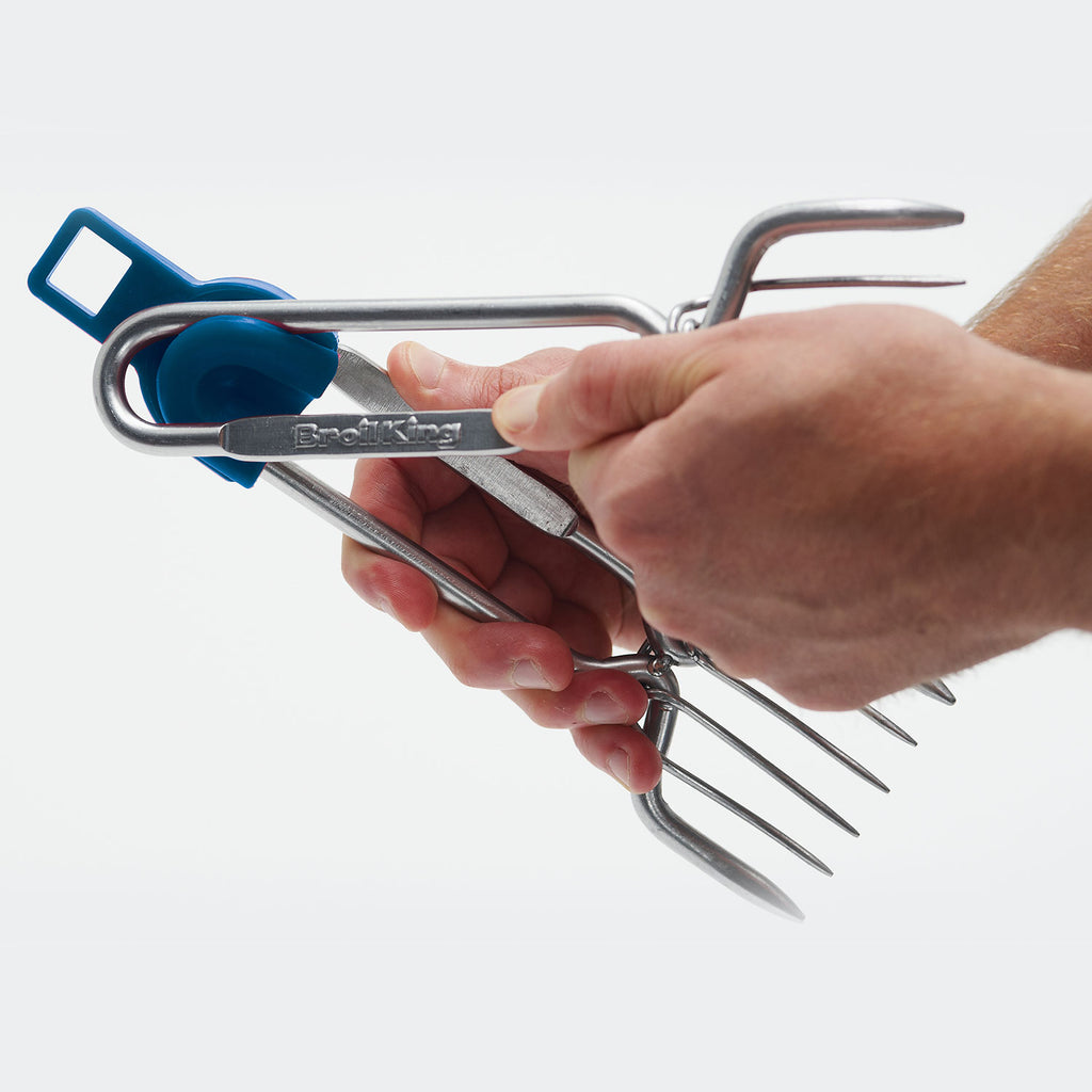 Stainless steel pork claws held by hand for lifting shredded pork