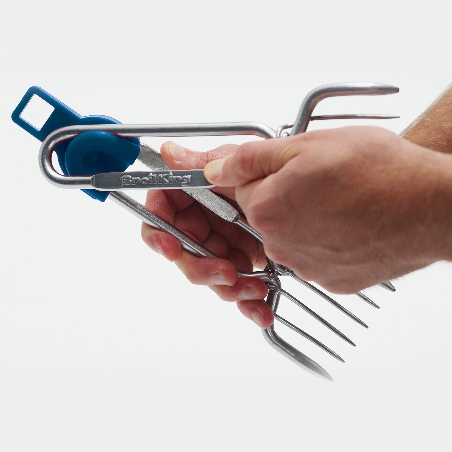 Stainless steel pork claws held by hand for lifting shredded pork