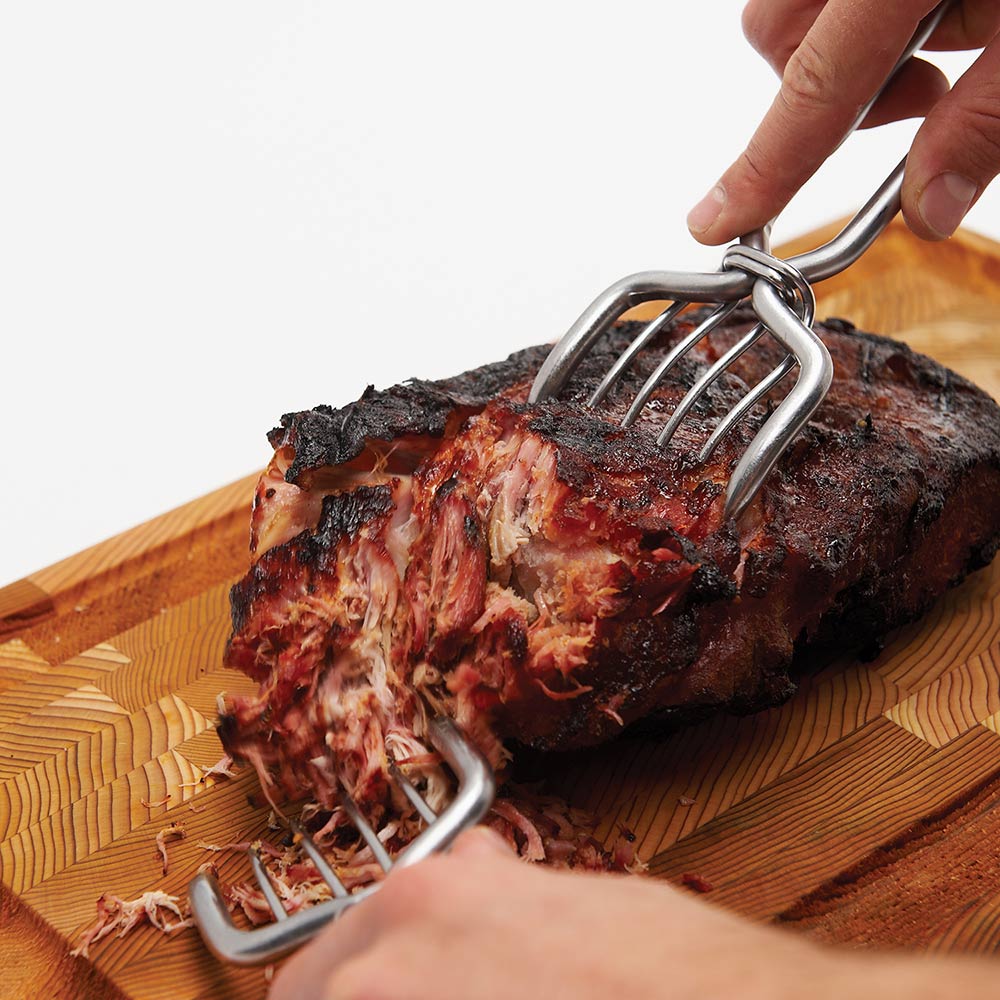 Stainless steel pork claws pinching shredded pork with curved tines