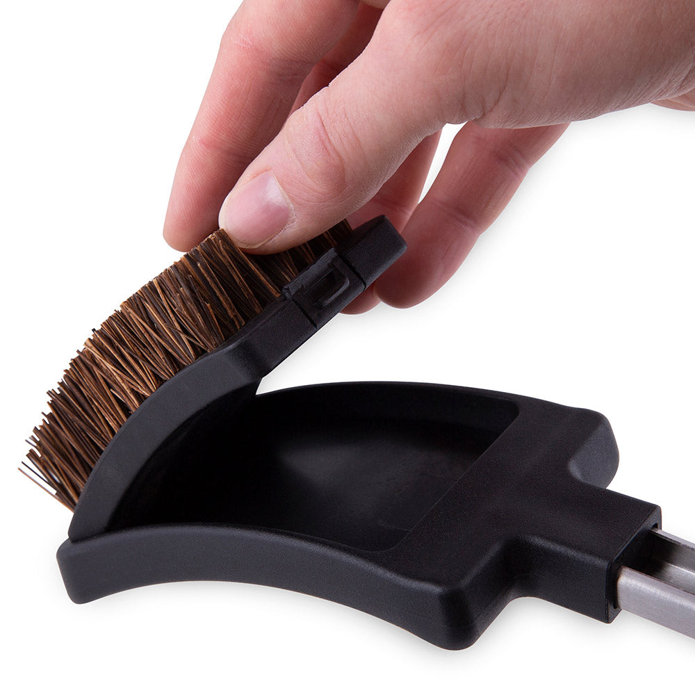 Grill brush head with copper bristles and black plastic base, angled for cleaning