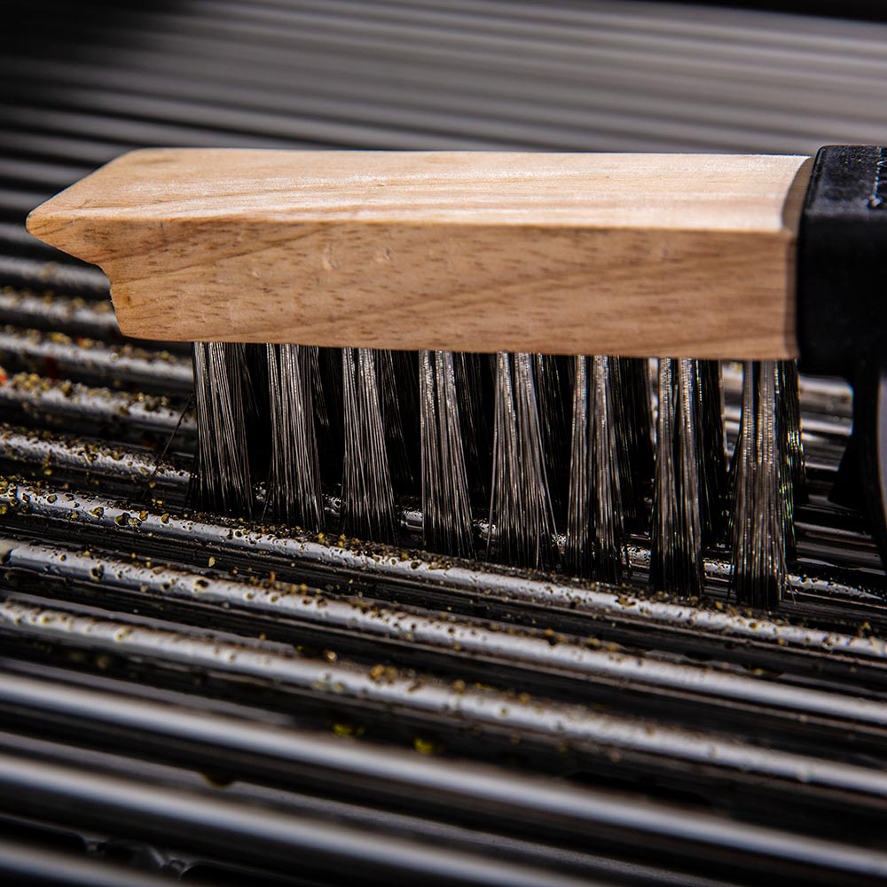 Grill brush bristles on a dirty grill grate