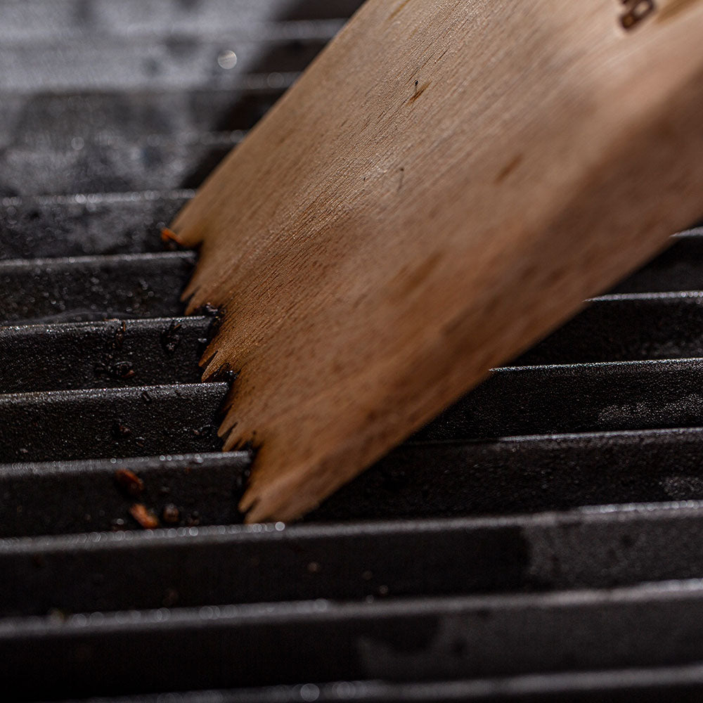 Wood BBQ grill scraper blade with serrated brush tips scraping grill grates