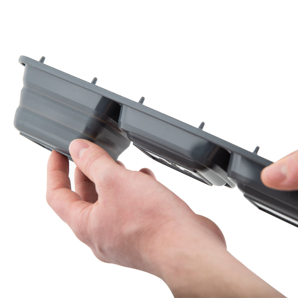 Ice tray insert with removable compartments, hand holding the upper block