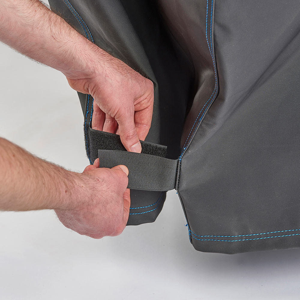 Hand fastening tab on polyester grill cover, blue-trimmed edge