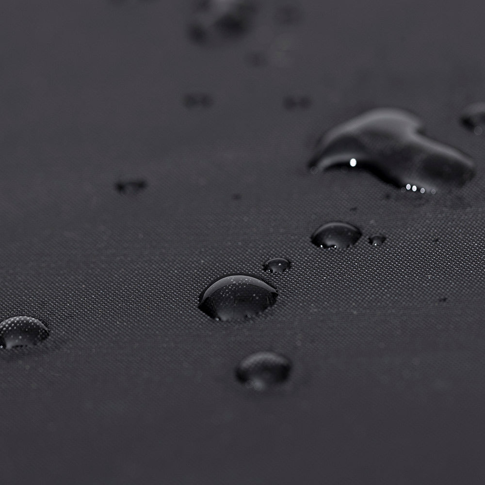 Black grill cover material with water droplets beading on the surface