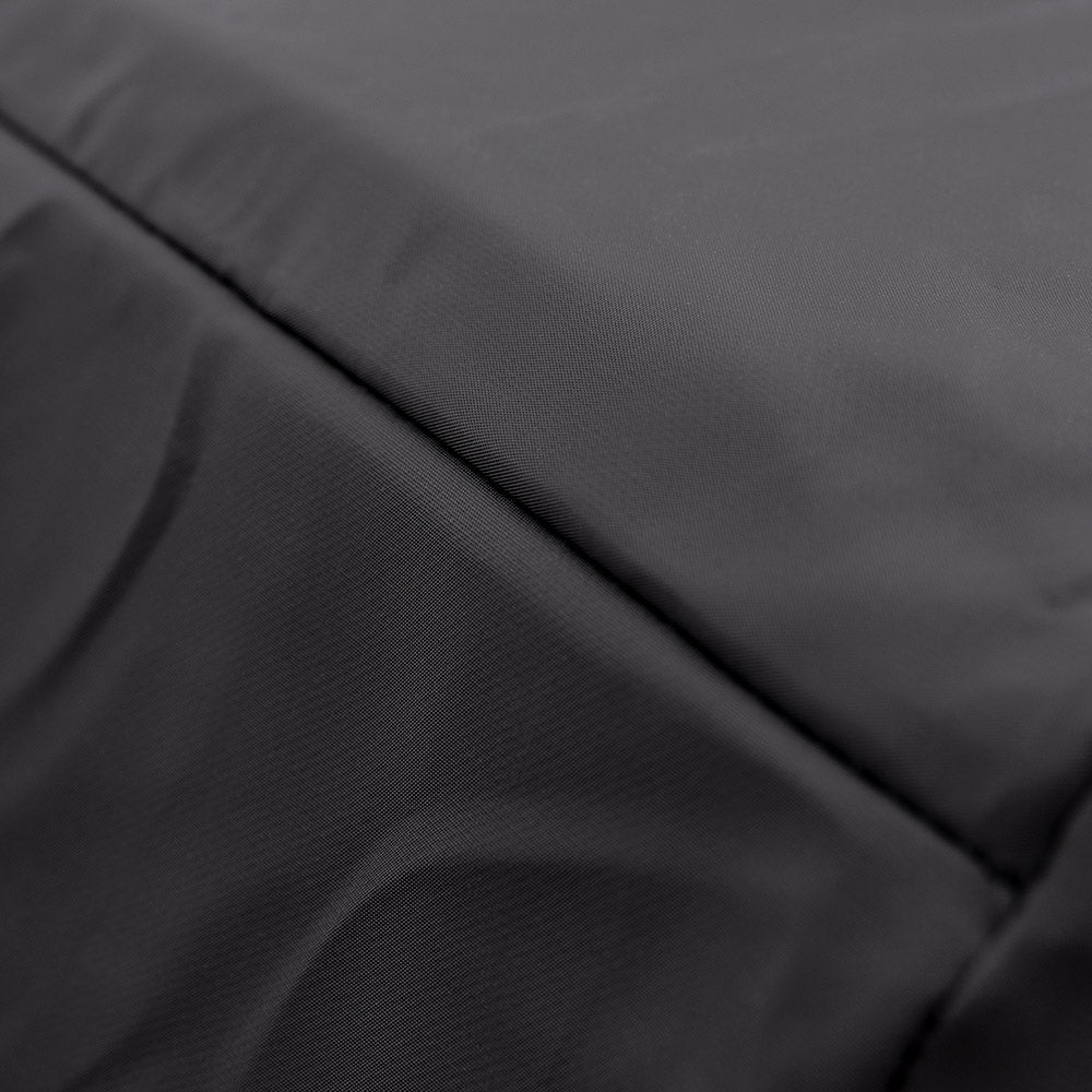 Close-up of black grill cover fabric weave and stitched seam lines