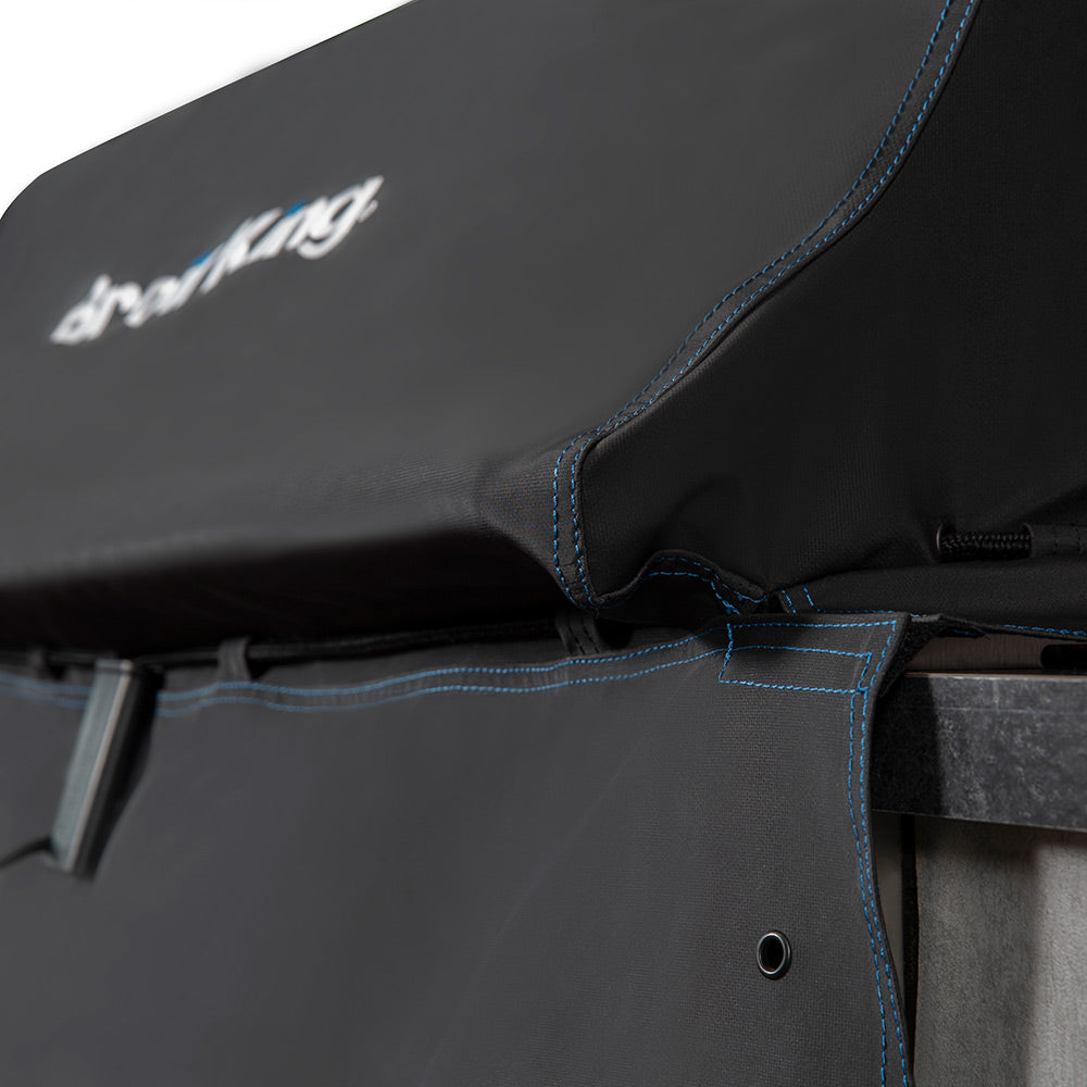 Black grill cover corner with blue stitched edging and securing strap