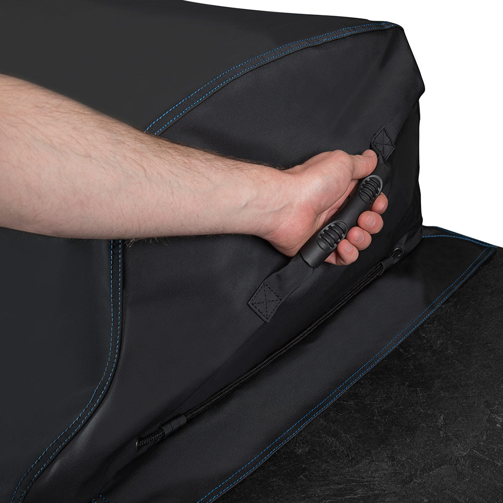 Black grill cover corner being pulled tight with an adjustable strap