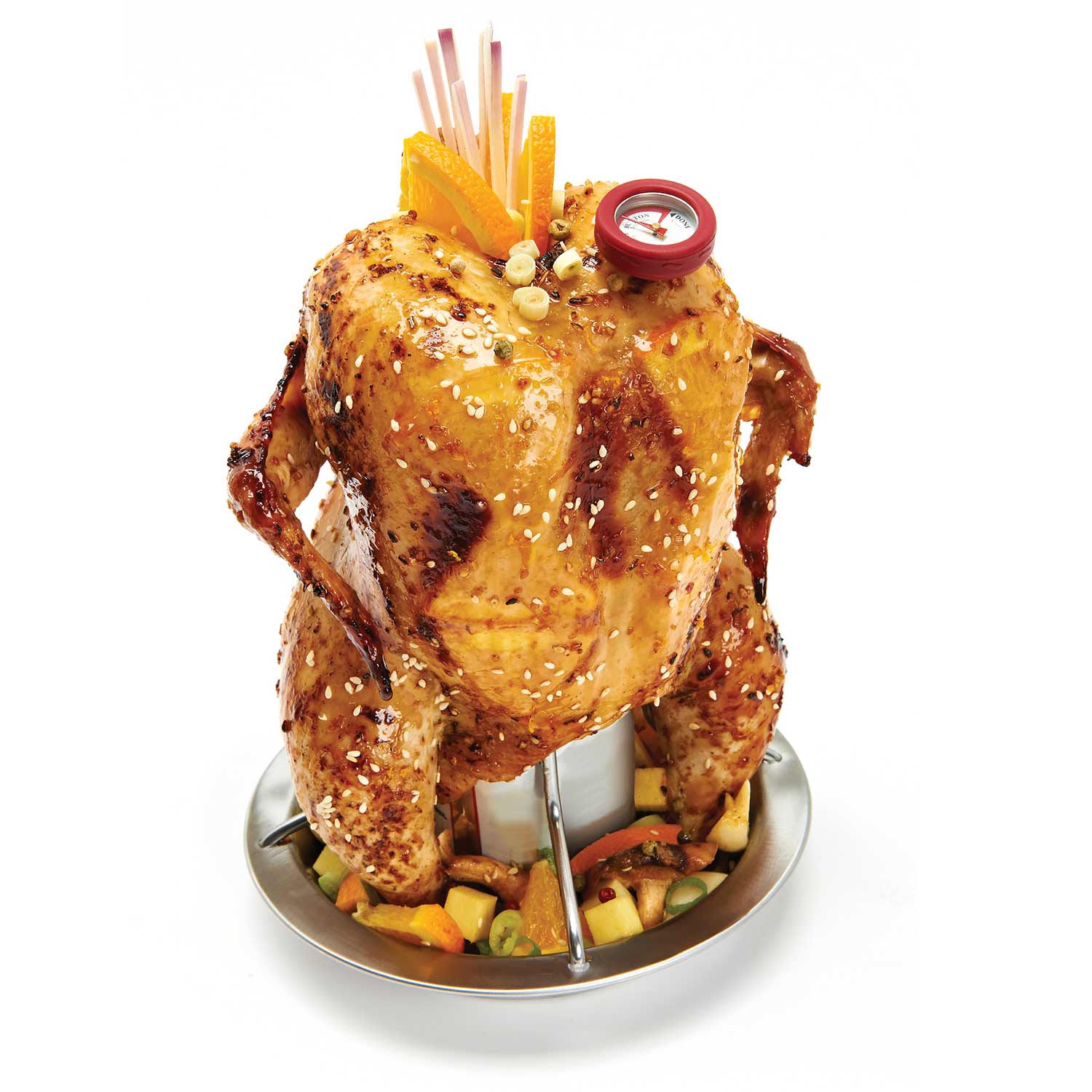Whole roasted chicken on a vertical roaster stand with vegetables in the tray