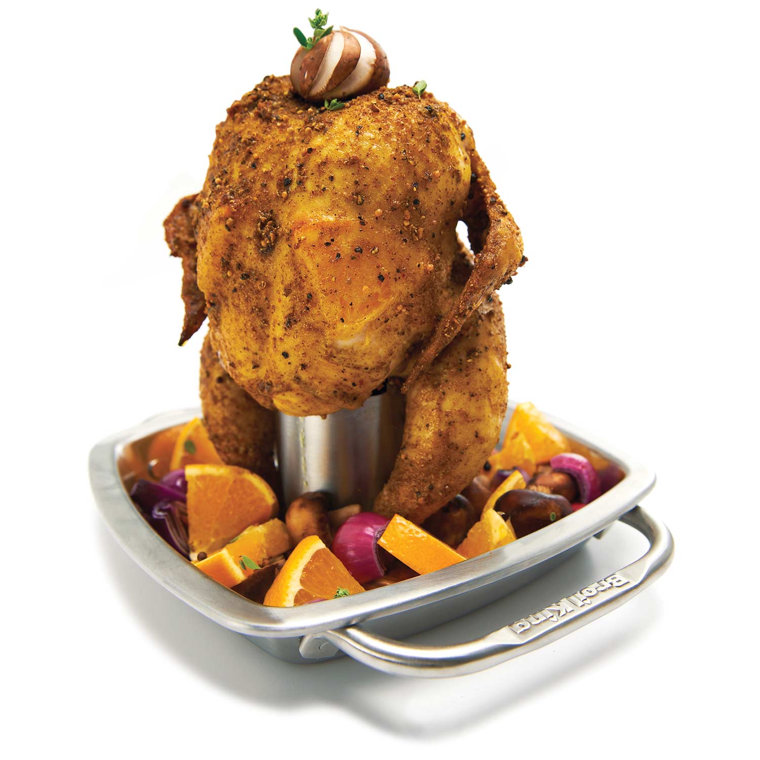 Stainless steel chicken roaster pan holding a seasoned whole chicken with vegetables