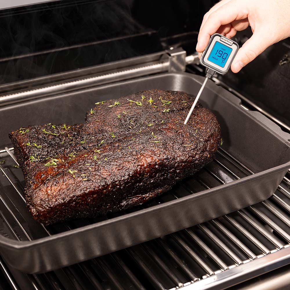 Cast iron multi roaster opened, roast on rack with instant-read thermometer