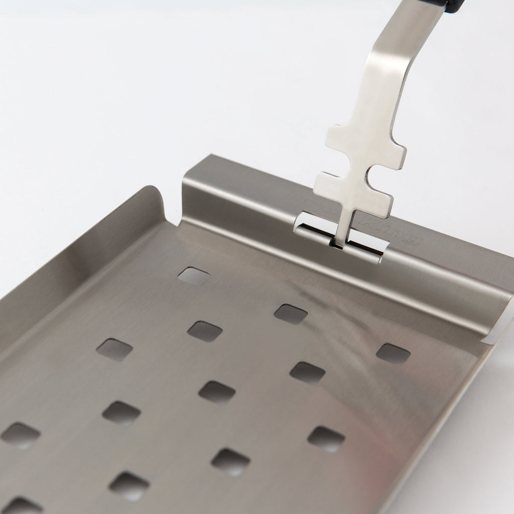 Stainless steel grill topper tray with slotted drainage holes and raised lip